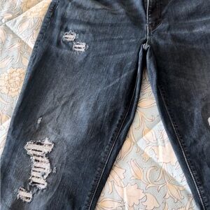 Women’s dark blue White House black market skinny jeans with detailed holes.